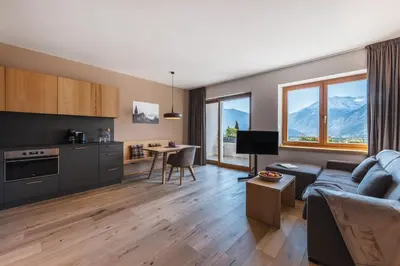 a living room with a couch and a table at Charming Suite by Dornsberg Panoramic Apartments in Schenna