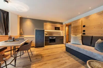 a living room with a couch and a table at Suite del Podesta' in Moena