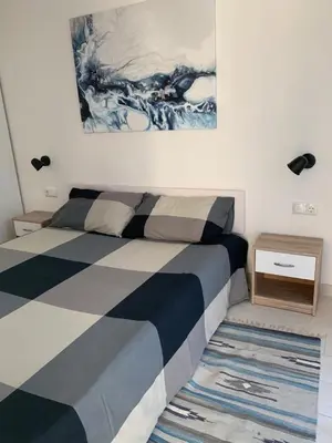 a bedroom with a bed and a painting on the wall at Al cantuccio di Chiara in Brunico