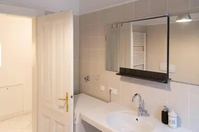 a bathroom with a sink and a mirror at Cityappartment Villa Landeck in Merano