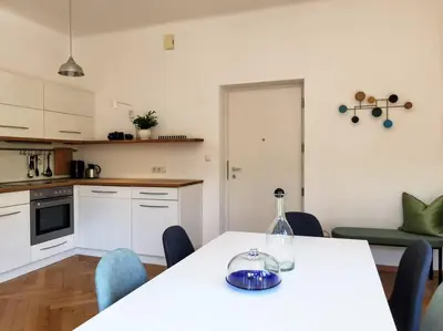 a kitchen with a table with a bottle on it at Cityappartment Villa Landeck in Merano