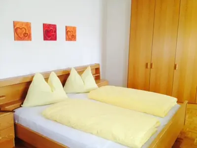 a bed with white sheets and pillows in a room at B&B Zum Guten Tropfen in San Paolo
