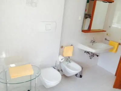 a bathroom with a toilet and a sink at B&B Zum Guten Tropfen in San Paolo