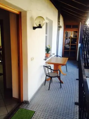 a small table and chairs in a room with a hallway at B&B Zum Guten Tropfen in San Paolo