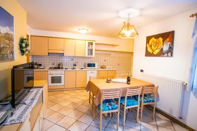 a kitchen and dining room with a table and chairs at Villa Rosa in Vigo di Fassa