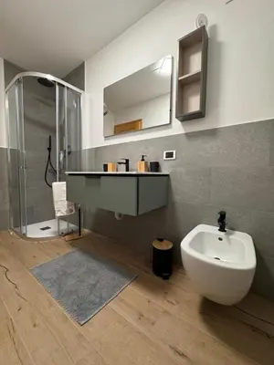 a bathroom with a sink and a toilet and a mirror at Villa Rosa in Vigo di Fassa