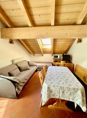 a living room with a table and a couch at Villa Rosa in Vigo di Fassa