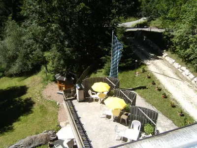 an aerial view of a toy train yard with tables and umbrellas at Gassermühle-Ferienhaus in Eggen