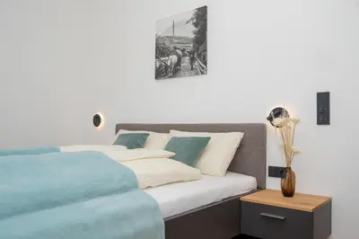a bedroom with a bed and a vase on a table at Justina 7 Apartments in San Paolo