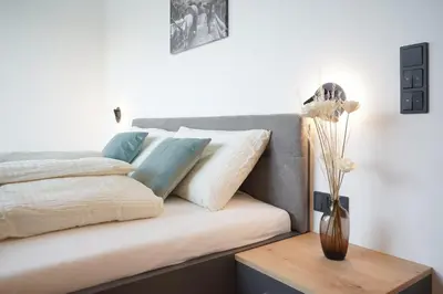 a couch with pillows and a vase on a table at Justina 7 Apartments in San Paolo