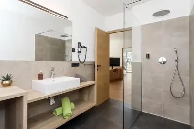 a bathroom with a sink and a shower at Justina 7 Apartments in San Paolo