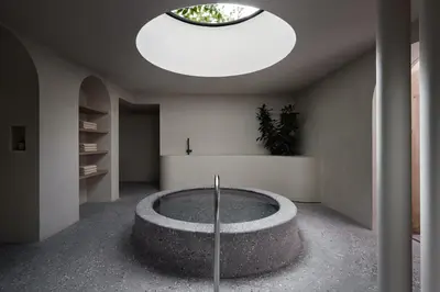 a room with a large circular pool in the middle of the room at fink Restaurant & Suites in Brixen