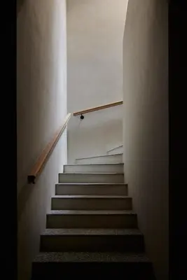 a staircase in a building with a stair case at fink Restaurant & Suites in Brixen