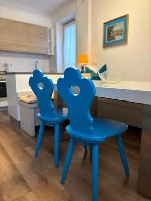 two blue chairs sitting next to a kitchen counter at Casa Latemar in Moena