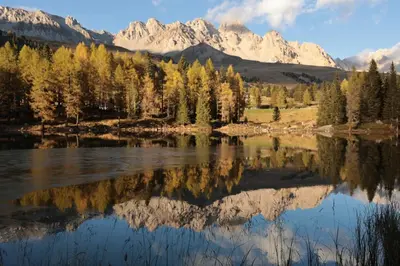 a view of a lake with mountains in the background at Casa Latemar in Moena