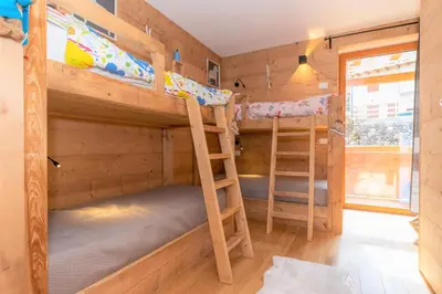 a bunk bed room with two bunk beds in a cabin at Casa Mari in Falcade