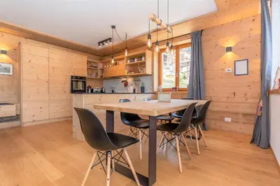 a kitchen and dining room with a table and chairs at Casa Mari in Falcade