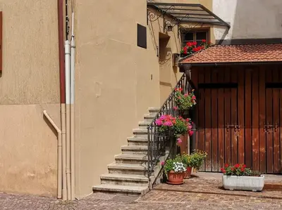 a staircase leading to a building with flowers on it at Verde di Valda in Valda