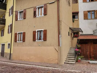 a building with windows and stairs on a street at Verde di Valda in Valda