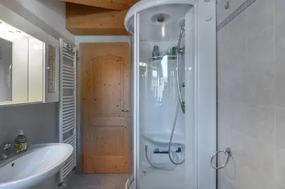 a bathroom with a shower and a sink at DolomiApartments - Appartamento Coronelle in Predazzo