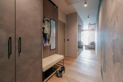 a room with a bench and a hallway at LA LIBELLA - slow living Suites in Merano