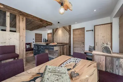 a bedroom with a large bed and wooden walls at Hinterscholerhof in Lazfons