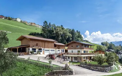 a group of buildings with a hill in the background at Hinterscholerhof in Lazfons