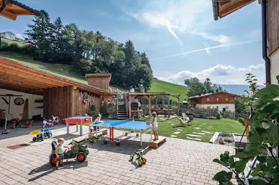 a backyard with a ping pong table and a playground at Hinterscholerhof in Lazfons