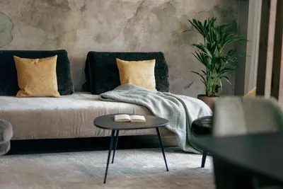 a living room with a bed and a table at La Libella - Suite #5 - la terrazza mit privatem Pool in Merano