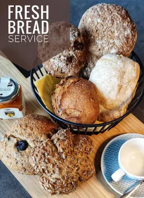 a bunch of different types of bread on a table at La Libella - Suite #5 - la terrazza mit privatem Pool in Merano