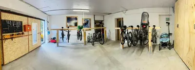 a room with a bunch of bikes parked in it at Dolomitihouse NOGHERA in Fiera di Primiero