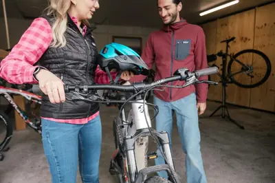 a man and a woman standing next to a bicycle at Dolomitihouse NOGHERA in Fiera di Primiero
