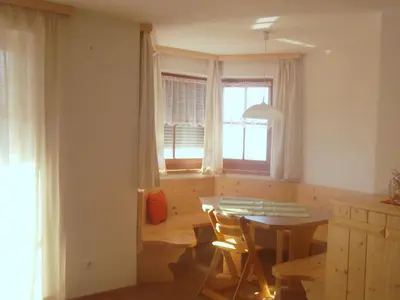 a kitchen with a table and chairs and a window at Parleitnerhof Ferienwohnung Morgenrot in Mühlbach