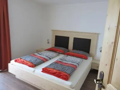 a bed with two pillows on it in a room at Parleitnerhof Ferienwohnung Morgenrot in Mühlbach