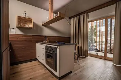 a kitchen with a stove top oven next to a window at Hosler in Merano