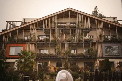 a building with a balcony with plants on it at Hosler in Merano