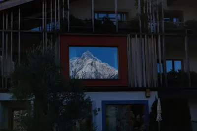 a view of a mountain through a window of a building at Hosler in Merano