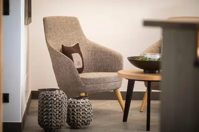 a chair and a table with a bowl on the floor at Natur Residence Kaiser Hans in Schenna