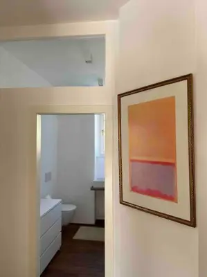 a bathroom with a painting hanging on the wall at Laurelia Suites in Merano