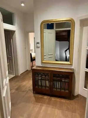 a room with a mirror on top of a dresser at Laurelia Suites in Merano