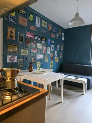 a kitchen with a white table and a wall with signs at Hope Home Trentino in San Martino di Castrozza