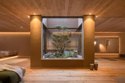 a room with a large window with a tree in it at Milla Apartments in Bressanone