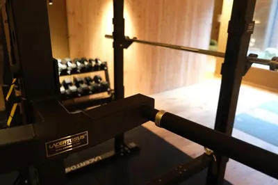 a view of a gym with a row of weights at Milla Apartments in Bressanone