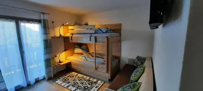 a room with a bunk bed in a room at Pixnerhof Urlaub auf dem Bauernhof in Schenna