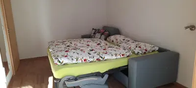 a small bed in a corner of a room at Pixnerhof Urlaub auf dem Bauernhof in Schenna