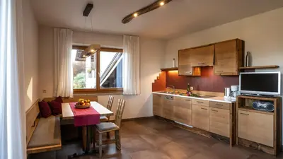 a living room with a couch and a tv at Dissertorihof in Caldaro