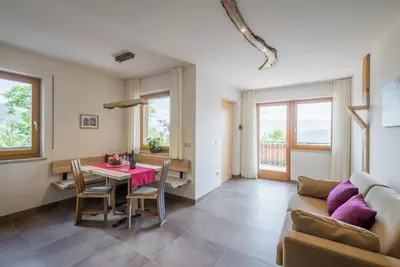 a living room with a couch and a table at Dissertorihof in Caldaro