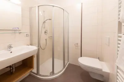 a bathroom with a shower and a sink and a toilet at Eich-hof in Caldaro
