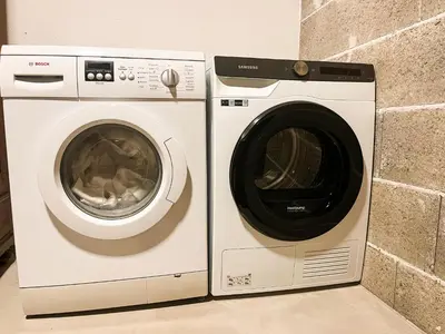 a washing machine and a dryer next to each other at Garden Apartment Untermühle in Bressanone