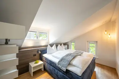 a bedroom with a large bed in a attic at Odilia - Historic City Apartments - center of Brixen in Bressanone